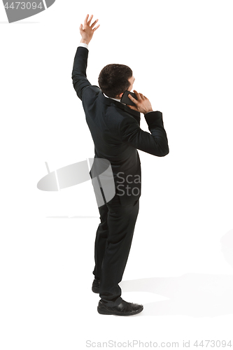 Image of Back view portrait of a businessman. Confident professional with mobile phone