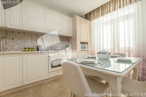 Image of Modern beige colored kitchen and dining room