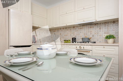 Image of Modern beige colored kitchen and dining room