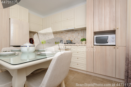 Image of Modern beige colored kitchen and dining room