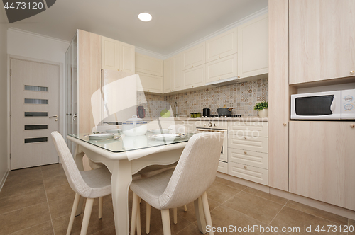 Image of Modern beige colored kitchen and dining room