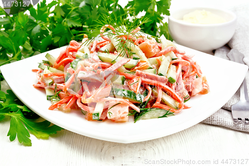 Image of Salad of sausage and spicy carrots with mayonnaise on light wood