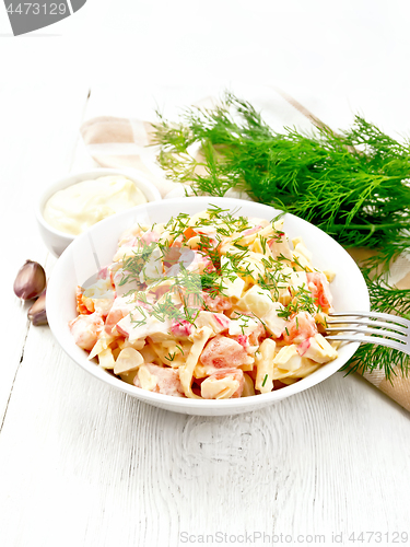 Image of Salad of surimi and eggs with mayonnaise on light table