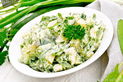 Image of Salad with potatoes and sorrel on wooden board