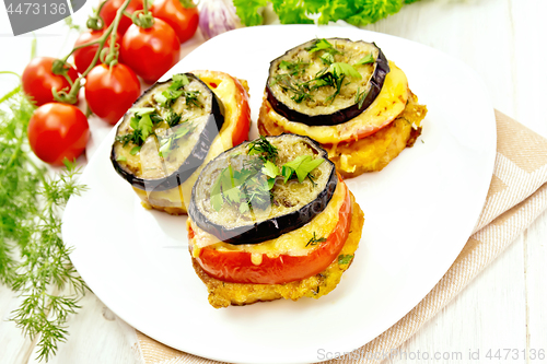 Image of Appetizer of aubergines and cheese in plate on light board