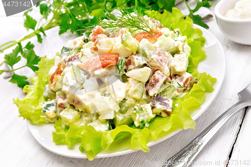 Image of Salad of salmon and avocado with mayonnaise on table