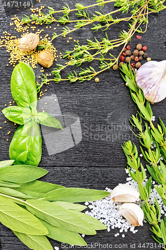 Image of Frame from herbs and spices on black wooden board