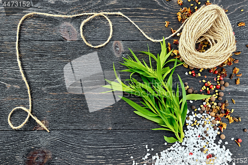 Image of Tarragon leaves with twine on black board