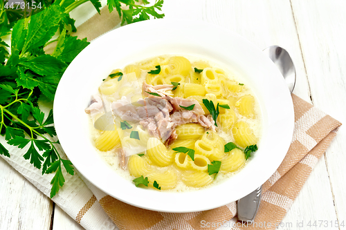 Image of Soup creamy of chicken and pasta in plate on wooden board