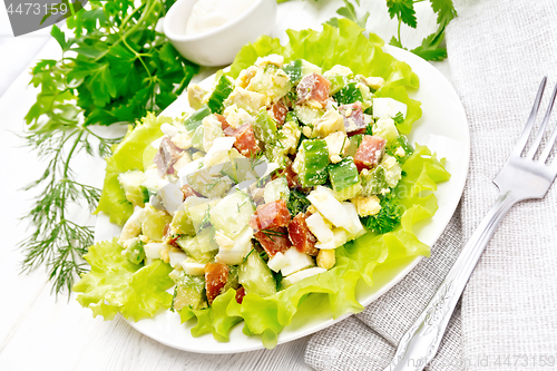 Image of Salad of salmon and avocado on wooden table