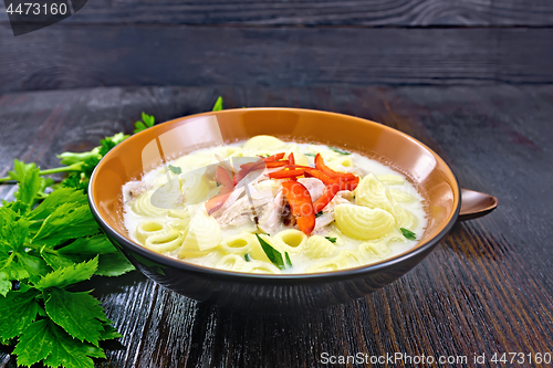 Image of Soup creamy of chicken and pasta with pepper in plate on table