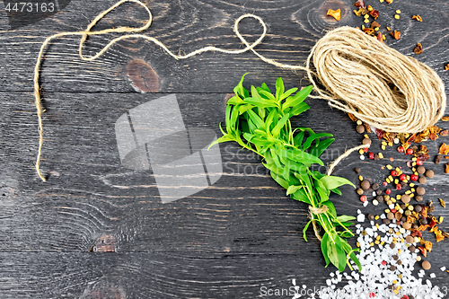 Image of Savory leaves with twine on black board