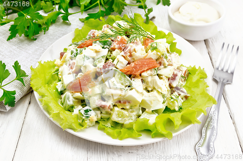 Image of Salad of salmon and avocado with mayonnaise on white board