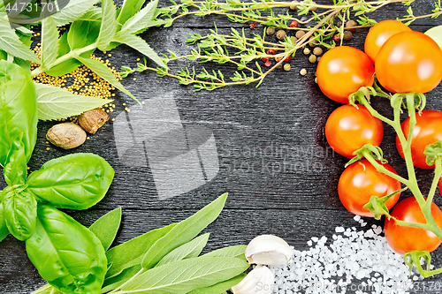 Image of Frame from herbs and tomatoes on black board