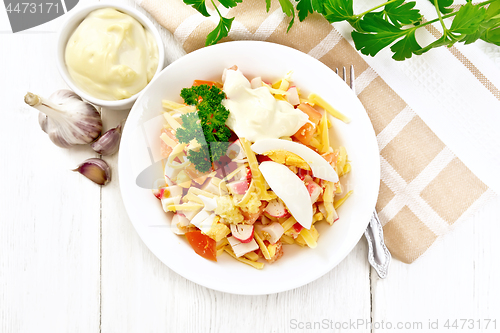 Image of Salad of surimi and tomatoes with eggs on board top