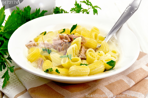 Image of Soup creamy of chicken and pasta in plate on napkin