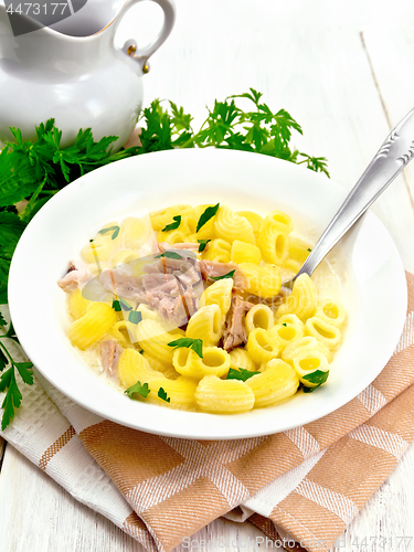 Image of Soup creamy of chicken and pasta in plate on board