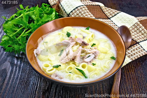 Image of Soup creamy of chicken and pasta in plate on dark table