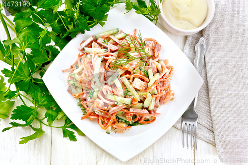 Image of Salad of sausage and spicy carrots with mayonnaise on table top