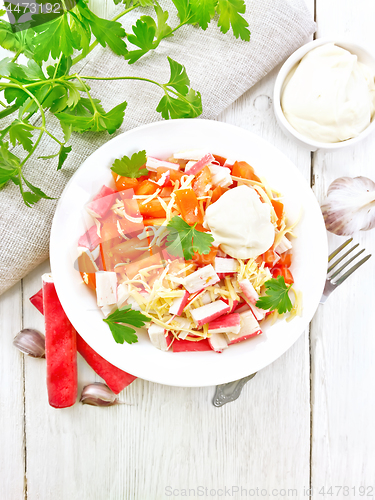 Image of Salad of surimi and tomatoes on light board top