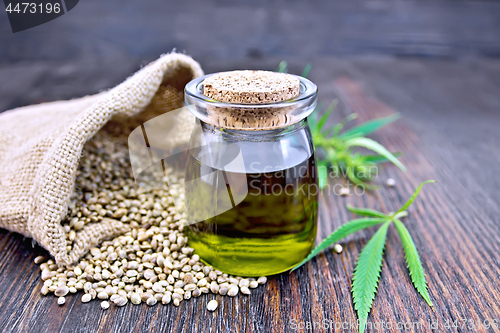 Image of Oil hemp in jar with seed in sack on board