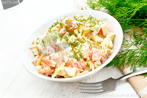 Image of Salad of surimi and eggs with mayonnaise on board