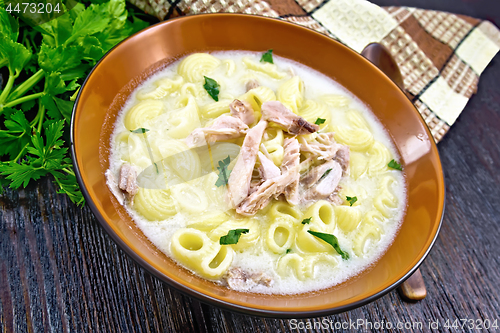 Image of Soup creamy of chicken and pasta in plate on dark board