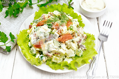 Image of Salad of salmon and avocado with mayonnaise on wooden board