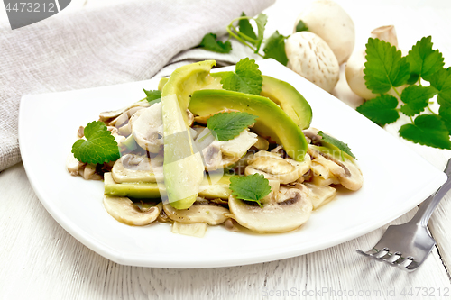 Image of Salad of avocado and champignons on table