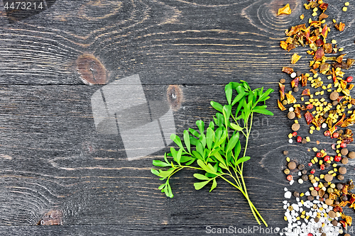 Image of Rue leaves with spices on black board