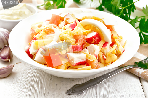 Image of Salad of surimi and tomatoes with eggs on light board