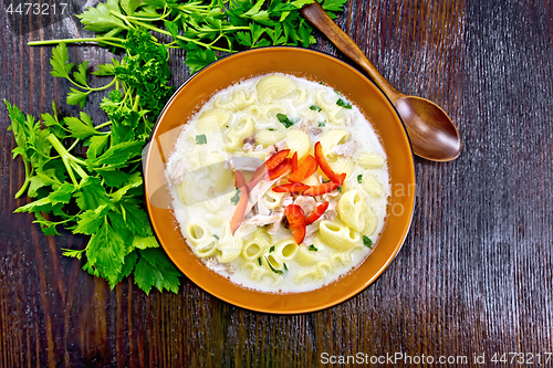 Image of Soup creamy of chicken and pasta with pepper in plate on table t