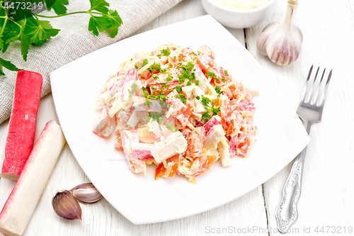 Image of Salad of surimi and tomatoes with mayonnaise on board