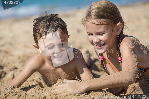 Image of Happy children playing on the beach at the day time.