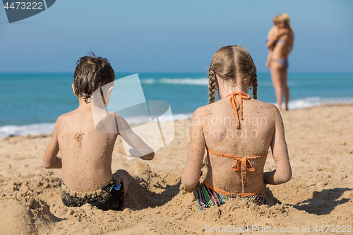 Image of Happy children playing on the beach at the day time.