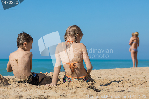 Image of Happy children playing on the beach at the day time.