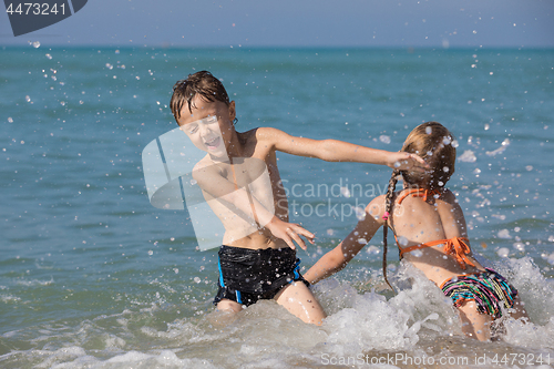 Image of Happy children playing on the beach at the day time.