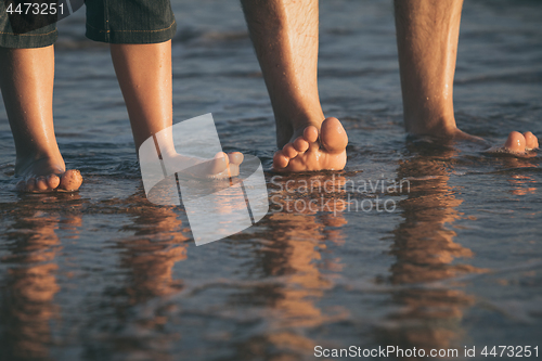 Image of Father and son playing on the beach at the day time.