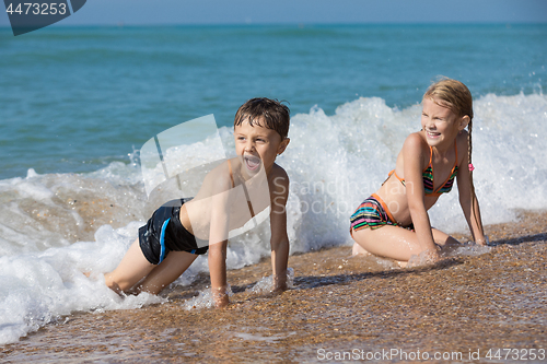 Image of Happy children playing on the beach at the day time. 