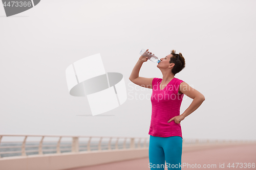 Image of Fitness woman drinking water