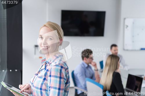 Image of Pretty Businesswoman Using Tablet In Office Building by window