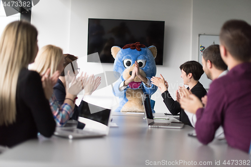 Image of boss dresed as bear having fun with business people in trendy of