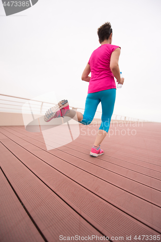 Image of woman busy running on the promenade