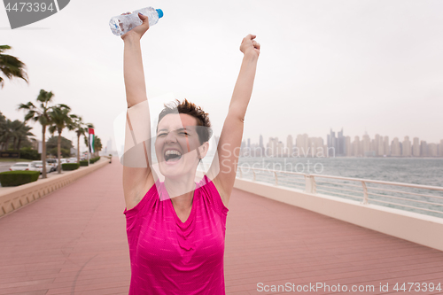 Image of young woman celebrating a successful training run