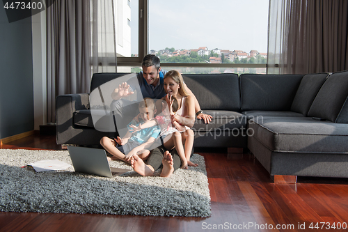 Image of Family Playing Together with laptop computer