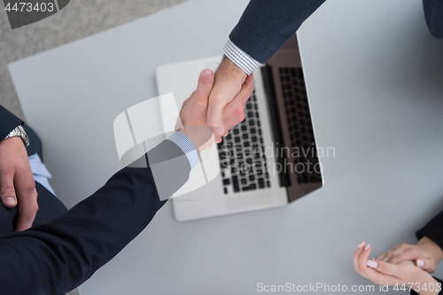 Image of cloasing the deal in modern office interior top view