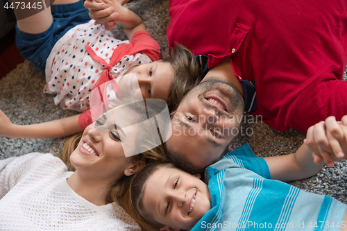 Image of happy family lying on the floor