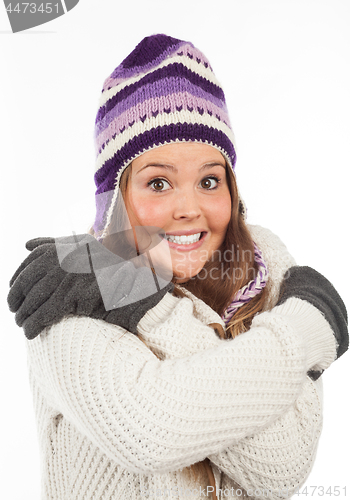 Image of Face of pretty woman with gloves and knitted winter cap  with smile