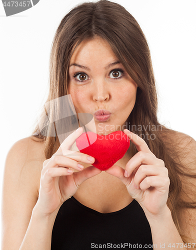 Image of young woman in love with a heart in hand