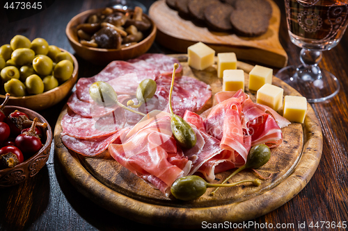 Image of Serrano ham platter with variation of appetizers